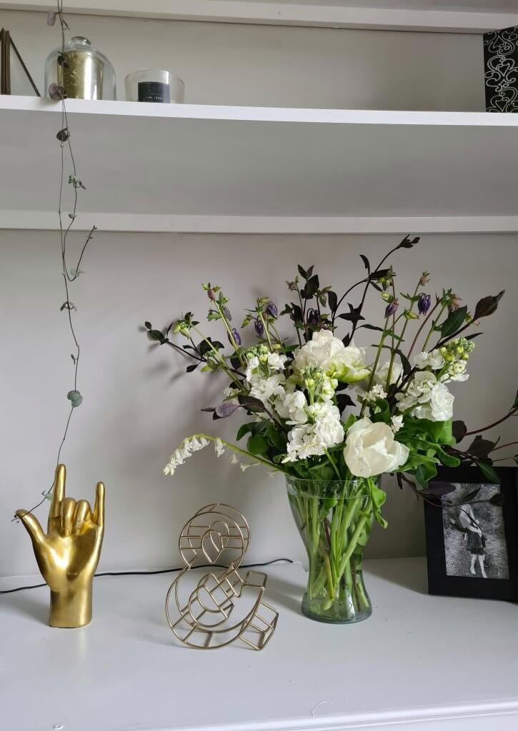 Vase of flowers with white flowers including stocks, tulips and white bluebells. 