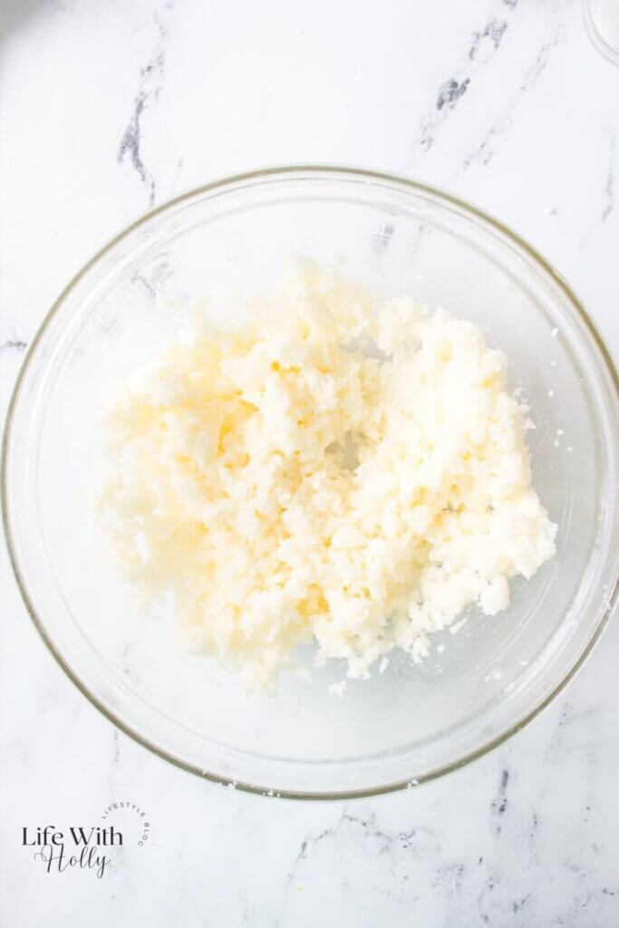 A mixing bowl with butter and sugar 
