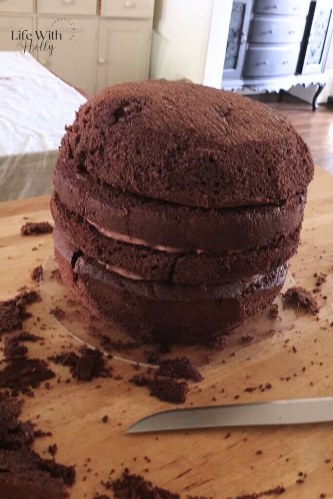 carving a chocolate cake to look like a pumpkin