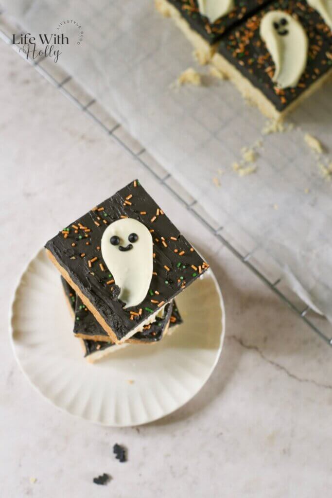 Halloween cookie bar, a shortbread cookie bar with black buttercream and a white chocolate ghost topper