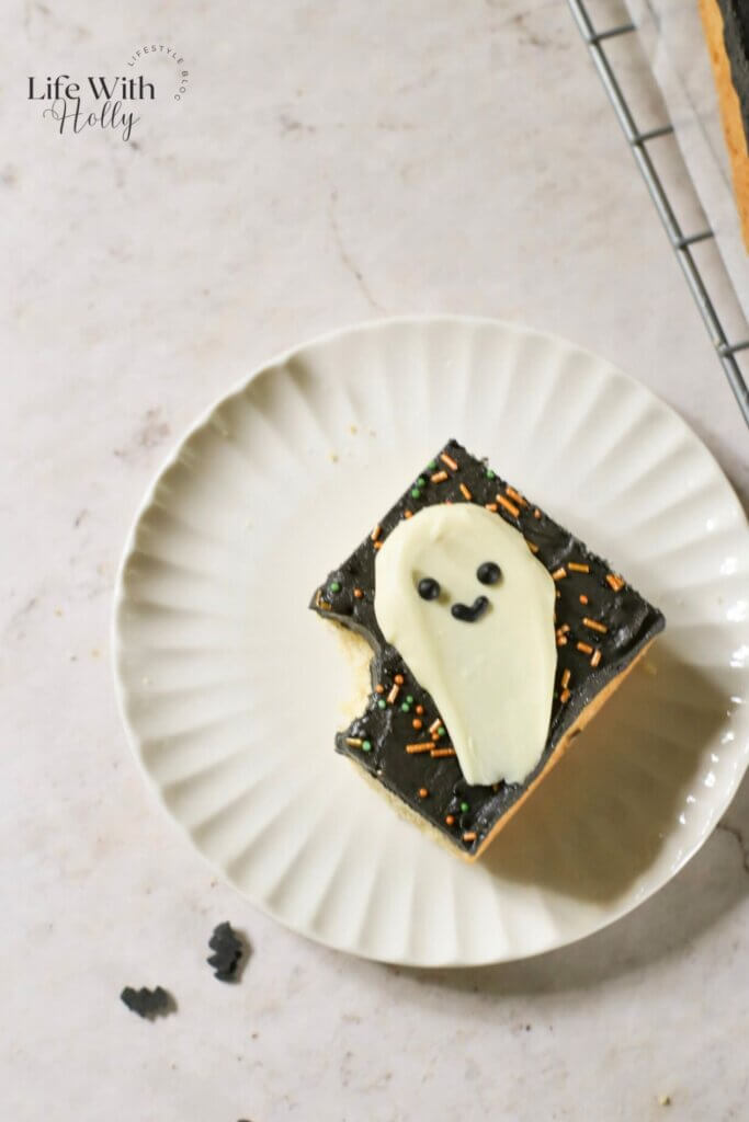 Halloween cookie bar, a shortbread cookie bar with black buttercream and a white chocolate ghost topper