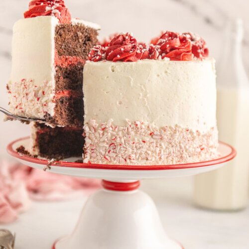Chocolate peppermint layer cake with a slice being lifted out